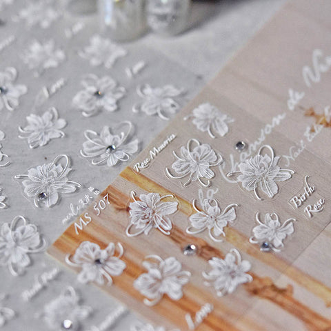 White flower nail sticker with crystal accents and detailed blossom