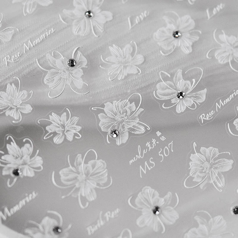 White flower nail sticker with crystal accents and detailed blossom