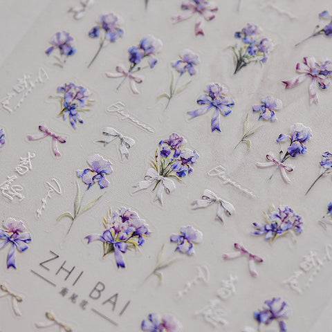 Nail stickers with vibrant blue flowers and bowknots