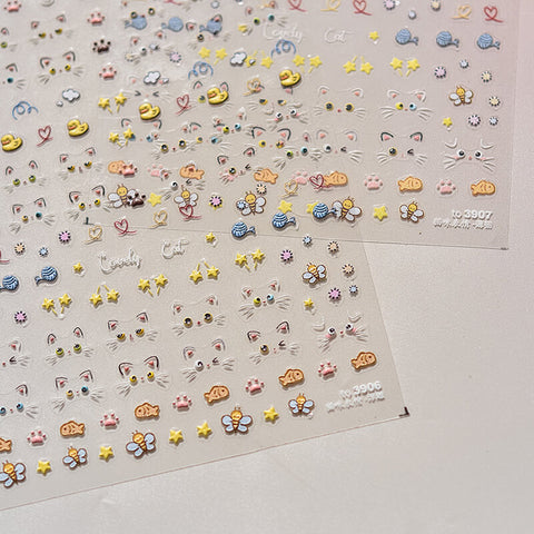 Cute cat emoji nail decal applied on a pink manicure