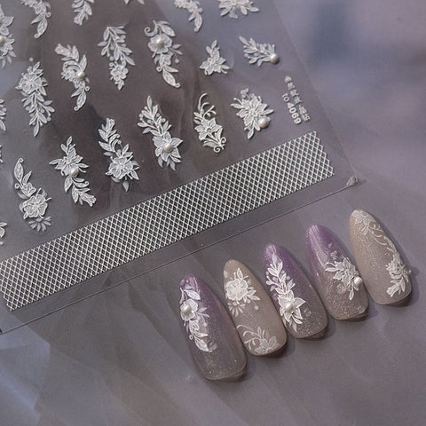 "Nails beautifully decorated with White Flower Nail Stickers and Pearl Nail Charm, showcasing elegant floral nail art