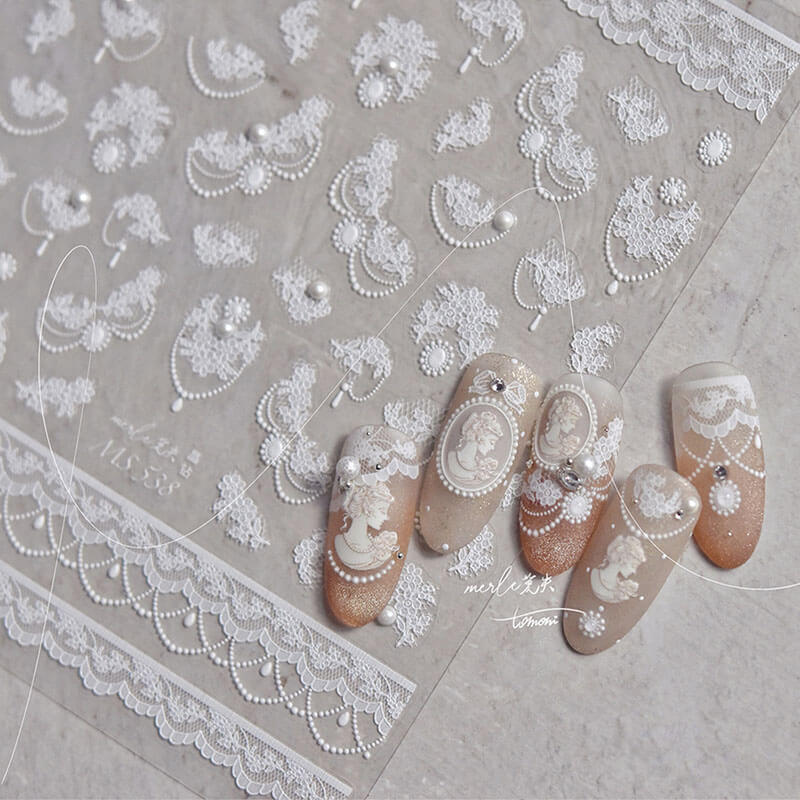 Nails adorned with Dainty Flower Pattern Nail Stickers, showcasing intricate lace pattern with pearls