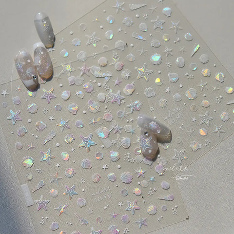 Sheet of star and shell-shaped nail art stickers on a light gray background with two nails featuring the design.