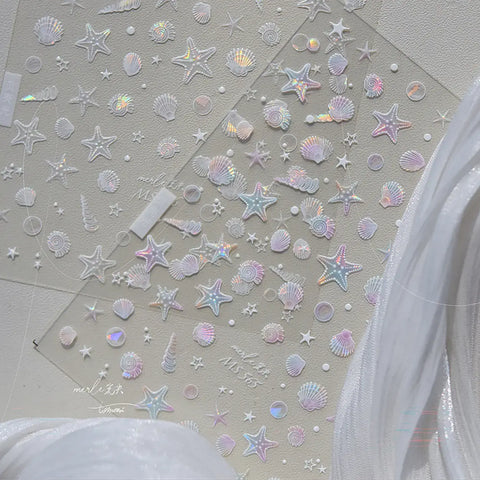Seashell and star-shaped stickers on a light gray background